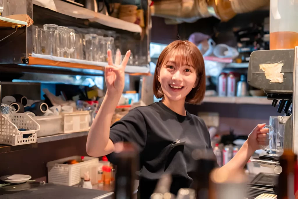 Female waitress using a beer server in a restaurant